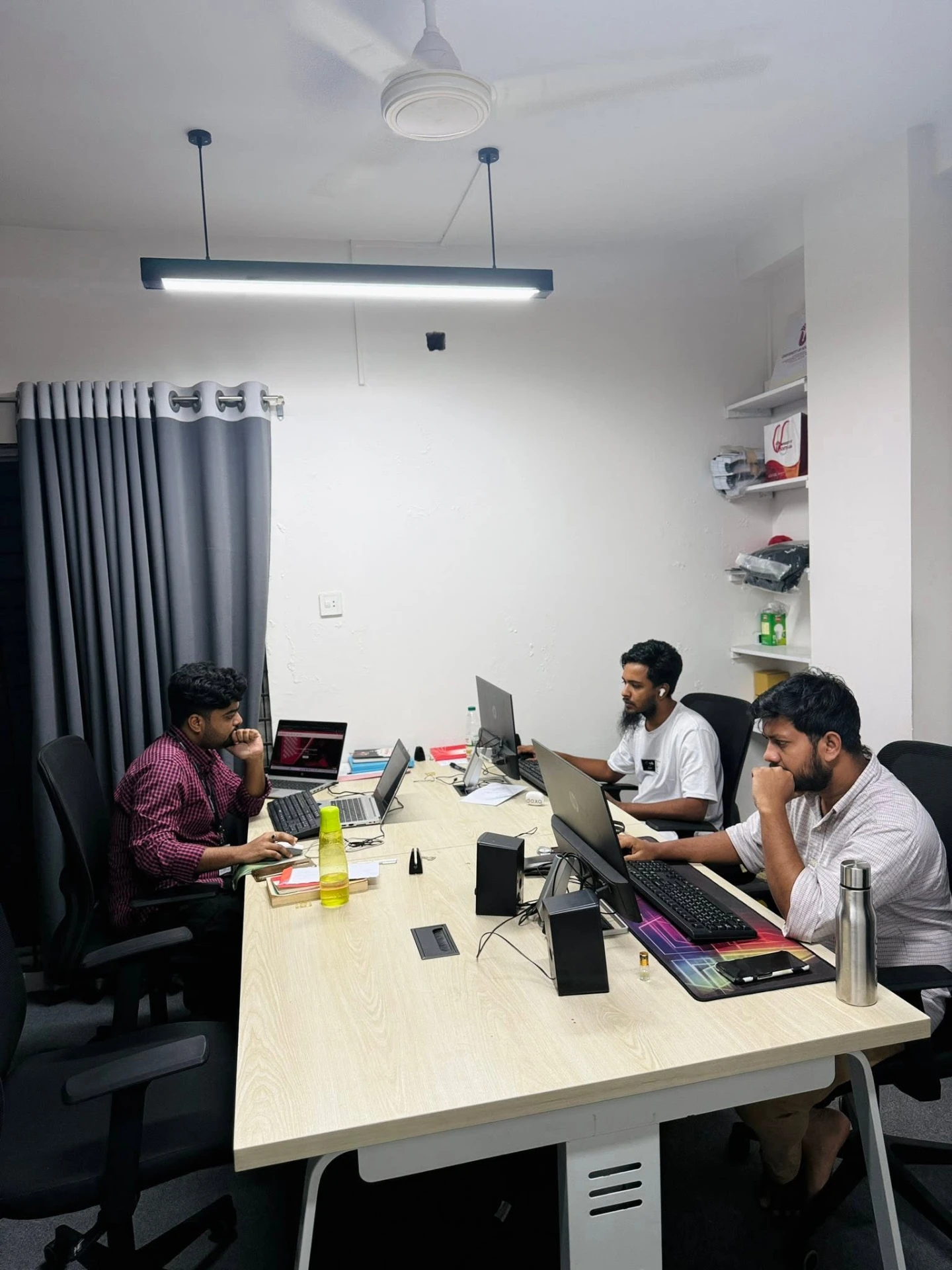 Three Gooseberry team members working together at the office desks
