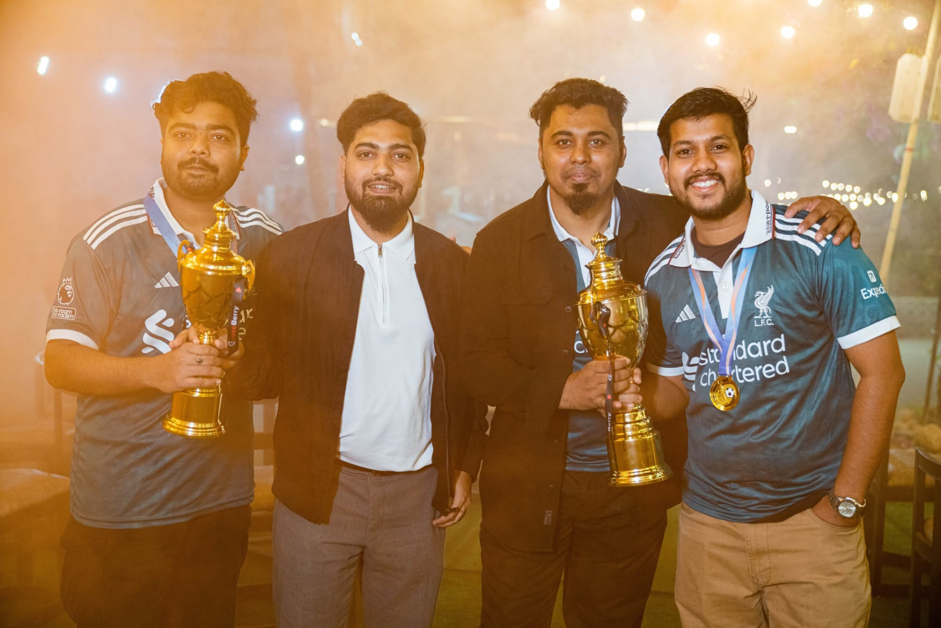 Gooseberry team members celebrating with championship trophies